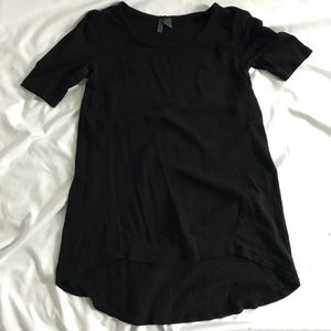 left of center | black tunic